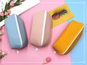 Vue détaillée de trois trousses colorées en cuir PU en bleu, rose et jaune vif.