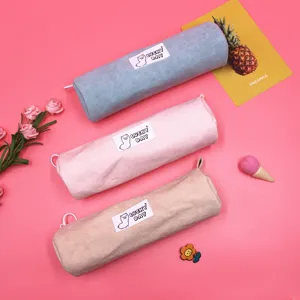 Detailed view of three Korean style corduroy pencil cases in blue, pink, and beige