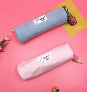Detail view of blue and pink corduroy pencil cases with Lucky Day label