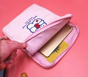 Detail view showing the internal capacity of the pink cartoon tablet sleeve with iPad