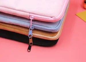 Detail of soft plush laptop sleeves in multiple colors showing zipper design