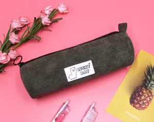 Detailed view of the dark olive corduroy fabric texture on a cylindrical pencil case.