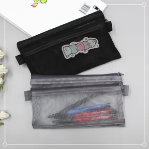 Detail of double-layer mesh pencil bags in black and grey for organized stationery storage