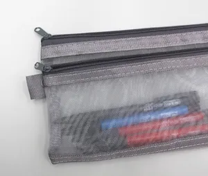 Close-up detail showing the double-layered grey mesh texture of this transparent pencil case