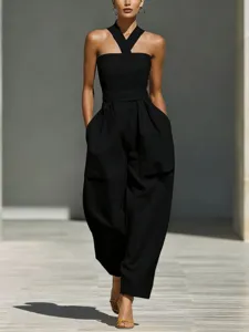 Black crossover halter neck wide leg jumpsuit for women, elegant loose linen blend clothing.