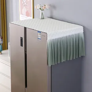 Quilted refrigerator dust cover with pleated green skirt for home appliance decoration.