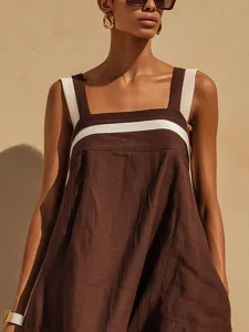 Close-up of cotton-linen blend dress showing square neck and striped detail.