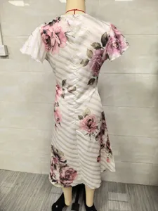 Detail view of women short sleeve floral print dress back design, elegant rose pattern.