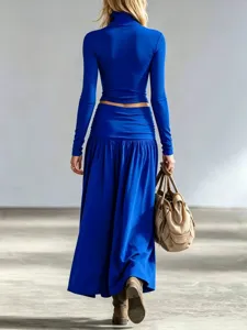 Back view of elegant royal blue turtleneck top and maxi skirt set for women