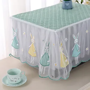 Detailed view of mint green lace dust cover with cute embroidered rabbit patterns