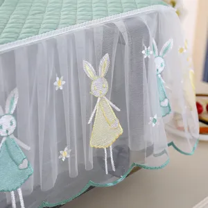 Macro view of lace microwave dust cover featuring cute embroidered rabbit and floral patterns