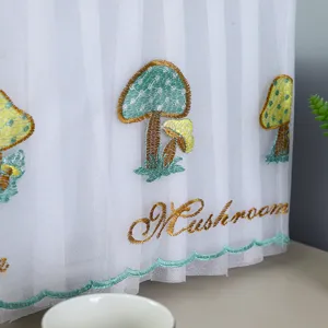 Close-up of detailed mushroom embroidery on white lace microwave dust cover fabric