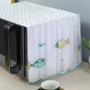 Close-up of white lace microwave cover with cute embroidered fish design details
