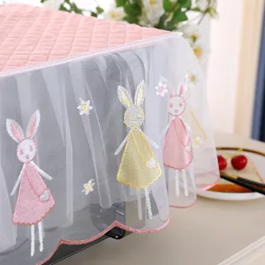 Detail of pink lace dust cover with embroidered rabbit patterns for microwave ovens
