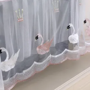 Detailed view of white lace dust cover featuring elegant pink swan embroidery for home decor
