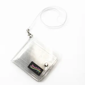 Detailed macro view of the transparent silver glitter PVC wallet featuring the Dongjin label