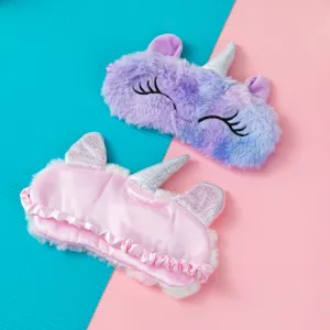 Detailed view of plush and satin unicorn sleep masks in soft pink and purple gradient