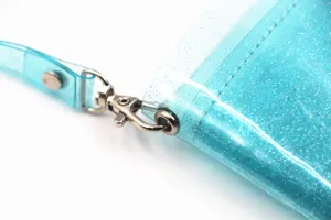 Close-up of lobster clasp on glittery blue transparent PVC neck pouch wallet