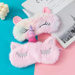 Detailed view of two cute plush unicorn sleep masks with shiny horns for restful sleep