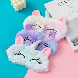 Detailed view of three soft plush unicorn sleep masks in pastel colors with silver horns