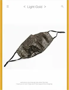 Close-up detail of a light gold sequined face mask showing shimmering texture and black ear loops
