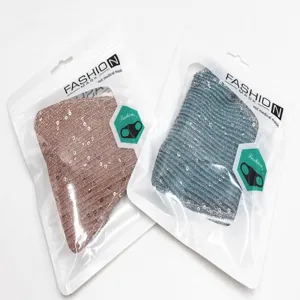 Two sparkly sequined fashion face masks in pink and blue individual packaging