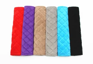 Detail view of plush quilted car seat belt shoulder pads in multiple colors