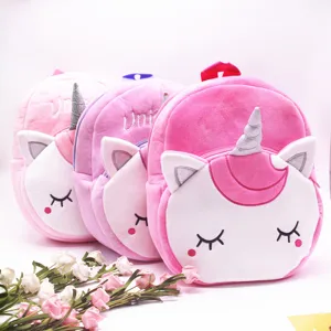Close-up detail of soft 3D horns and embroidered unicorn eyes on these plush pink backpacks.
