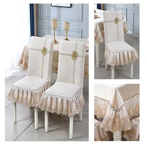 Detailed view of cream quilted chair covers and tablecloth with elegant lace trim