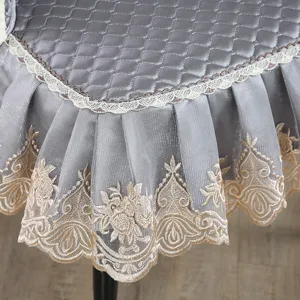 Close-up of grey quilted chair cover with elegant floral embroidered lace trim