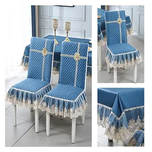 Detailed view of quilted blue chair covers and matching tablecloth with elegant lace ruffles