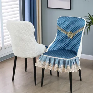 Detailed view of quilted blue chair cover with gold lace trim and floral accents.