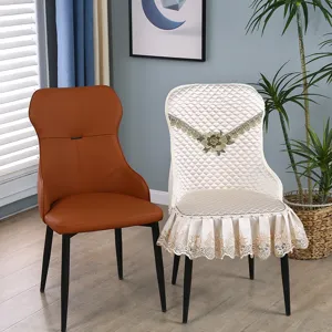Detailed view of quilted cream chair cover with lace trim and floral embroidery