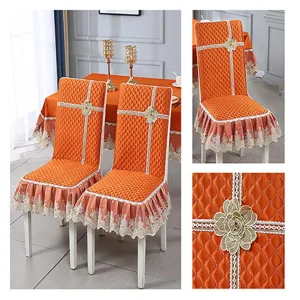 Detail view of orange quilted chair cover with elegant lace trim and flower accent