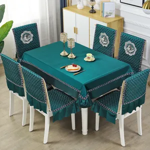 Detailed view of emerald teal quilted tablecloth and matching chair cover set for home dining room.