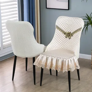 Elegant quilted chair cover with lace ruffles and floral embroidery for dining chairs