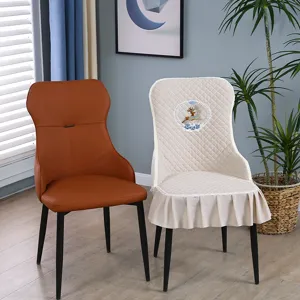 Close-up of cream quilted chair cover featuring decorative deer embroidery and ruffles