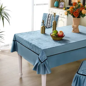 Elegant blue velvet tablecloth and matching chair cover set in a dining room set.