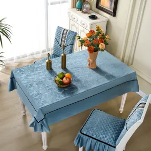 Detail showing the elegant light blue quilted chair covers and matching marble pattern tablecloth
