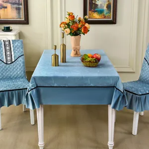 Light blue velvet tablecloth and matching ruffled chair covers in an elegant dining room
