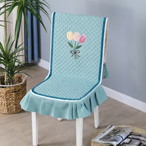 Modern one-piece quilted chair cover featuring an embroidered tulip floral pattern design