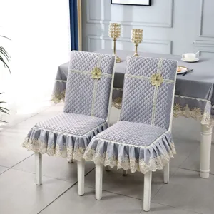 Elegant grey quilted chair covers with delicate lace trim and floral accents for dining