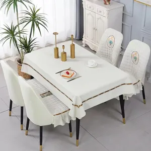 Elegant dining room scene with white quilted chair covers and matching tablecloth