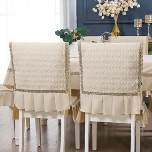 Detail of a premium quilted cream chair cover featuring elegant lace trim and ruffled edges