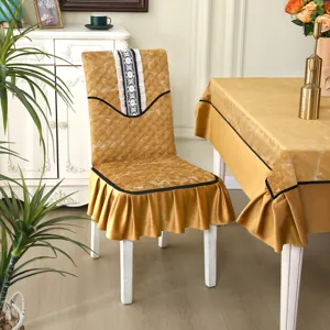 Macro view of golden quilted dining chair cover featuring elegant lace trim and ruffled skirt