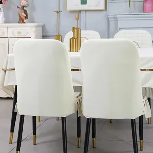 Detailed view of white stretch curved back chair cover in a home dining setting