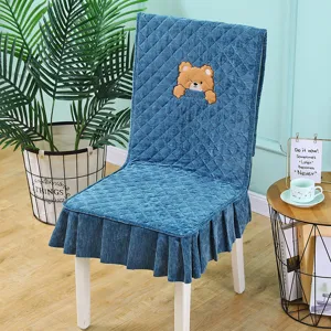 Blue quilted velvet dining chair cover with cute bear embroidery and ruffled skirt.