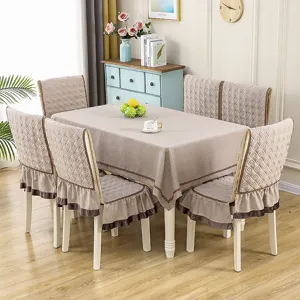 Dining table set with tablecloth and chair covers featuring a quilted diamond pattern