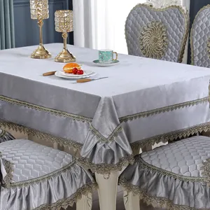 Luxurious grey velvet table linen set with intricate lace trim shown in a home dining setting