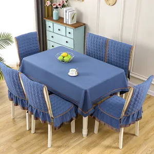 Detailed view of the blue quilted fabric tablecloth and matching ruffled chair cover set